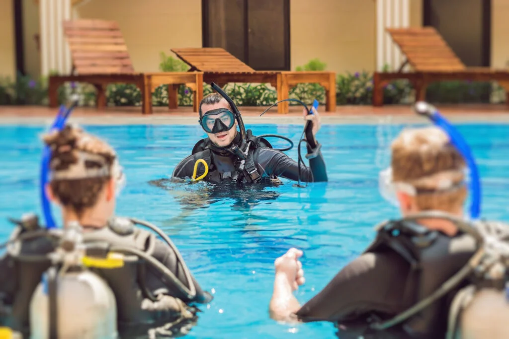 Certified scuba diver floating neutrally buoyant in clear water during skill review session